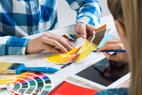 picture of professional house painting contractor showing customer a color swatch fan