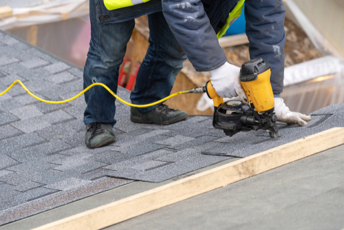 worker on roof providing roof repair service