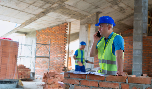 commercial general contractor supervising construction site